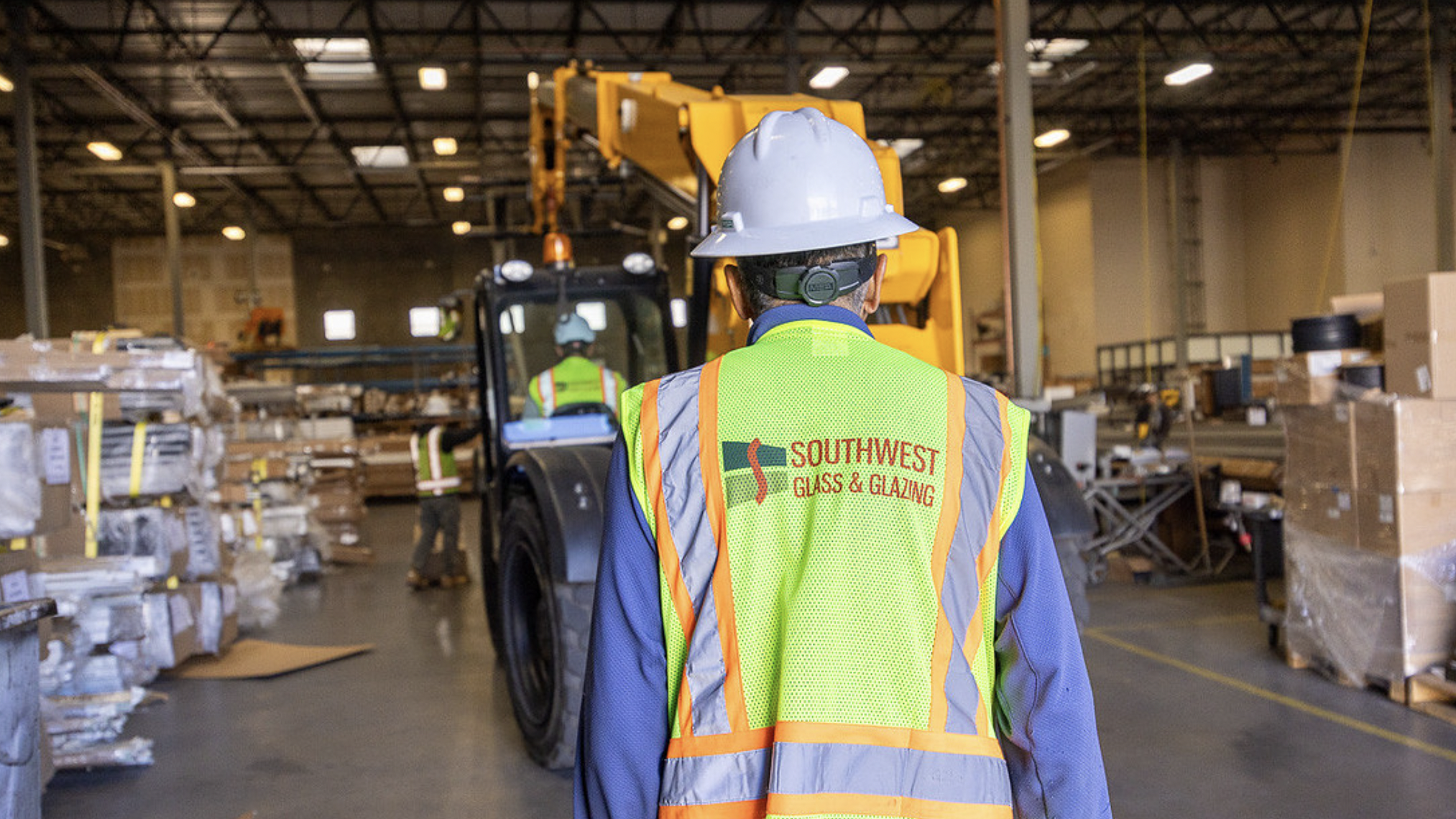 Southwest Glass - Team member wearing company vest and hardhat